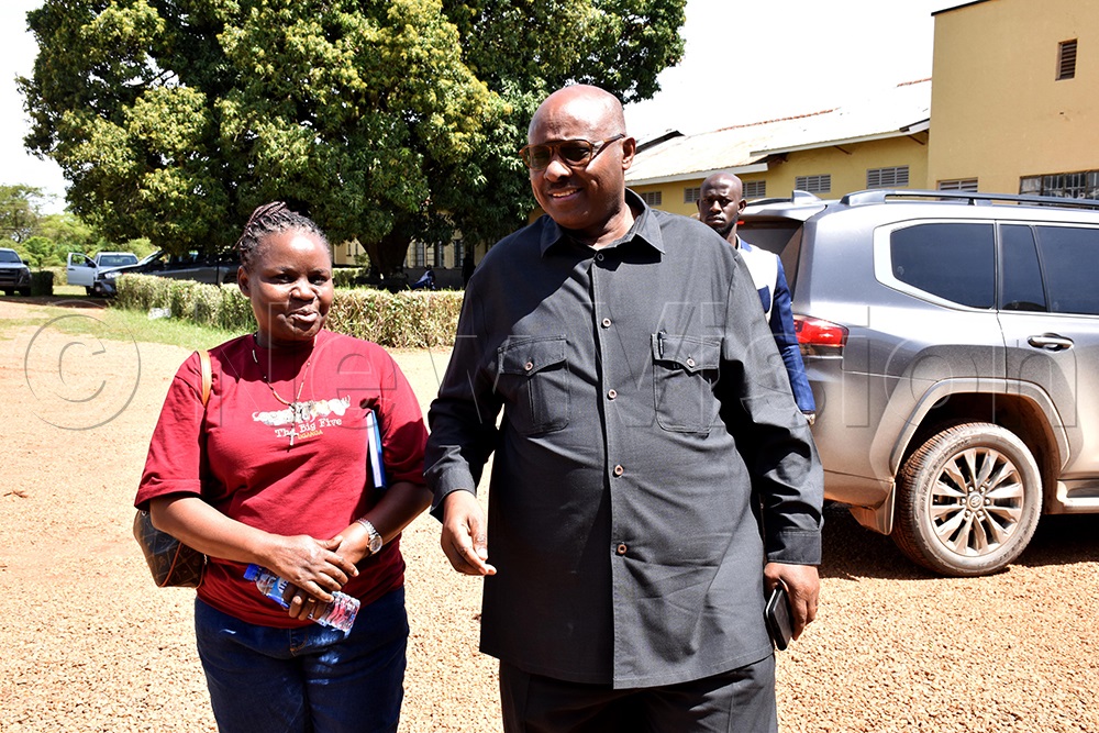 Joyce Babirye, the principal communication Officer of the Ministry of local government, sharing a light moment with Ben Kumumanya, the permanent Secretary of the Ministry of Local Government shortly after his arrival at the National Leadership Institute (NALI), Kyankwanzi. (Photo by Simon Peter Tumwine)