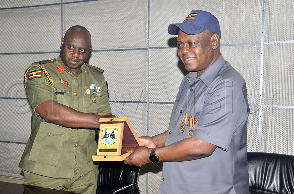 Chris Bagonza, Brig. Gen. Deputy Commandant Senior Command and Staff College, Kimaka Jinja, presents a gift to Prof. Charles Kwesiga (right), Executive Director of Uganda National Research Institute, during a visit by a delegation of Africa soldiers at Namanve Industrial, March 2026. (Photo by Wilfred Sanya)