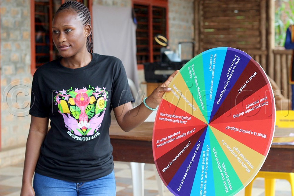 Miriam Kanyago, a menstrual health activist from the Buntu Wellbeing Experience Network, explains menstruation using the spinning game. (Photo by Richard Ategeka)
