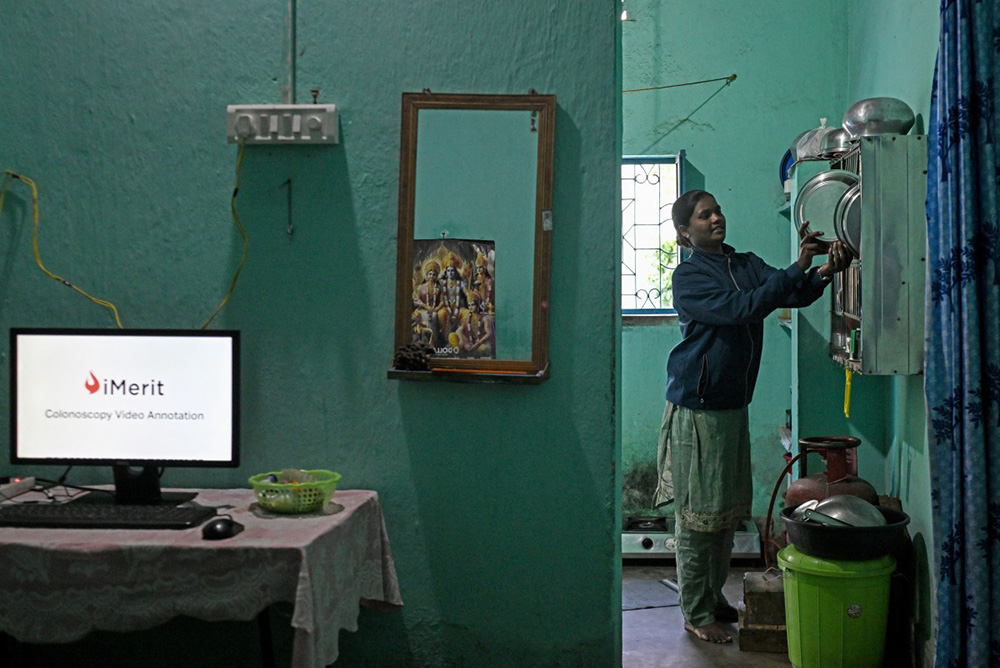 This photograph taken on January 16, 2026 shows AI data labeller Chandmani Kerketta working in a kitchen of a rented room for her work-from-home setup in Ranchi in India's Jharkhand state.  (Photo by Arun SANKAR / AFP)