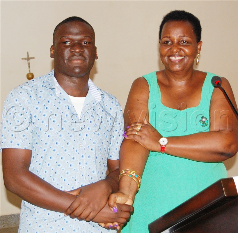 The headteacher of Our Lady of Good Counsel SSS Gayaza, Lady Agnes Ssebayigga (right) congratulates one of the school's star performers.