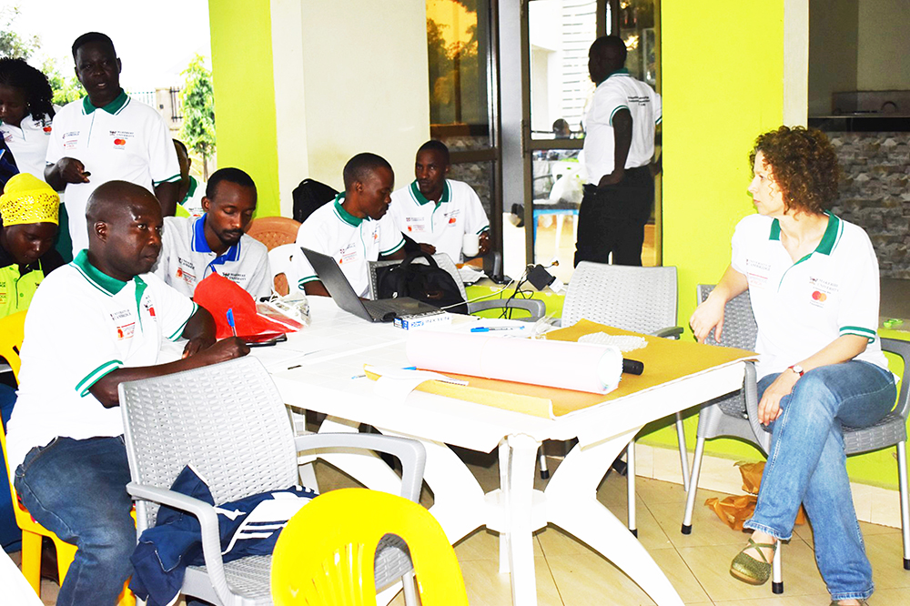 Dr Irit Katz from Cambridge University discussing with refugees at Farmers Lounge, Kikuube District. (Courtesy photo)
