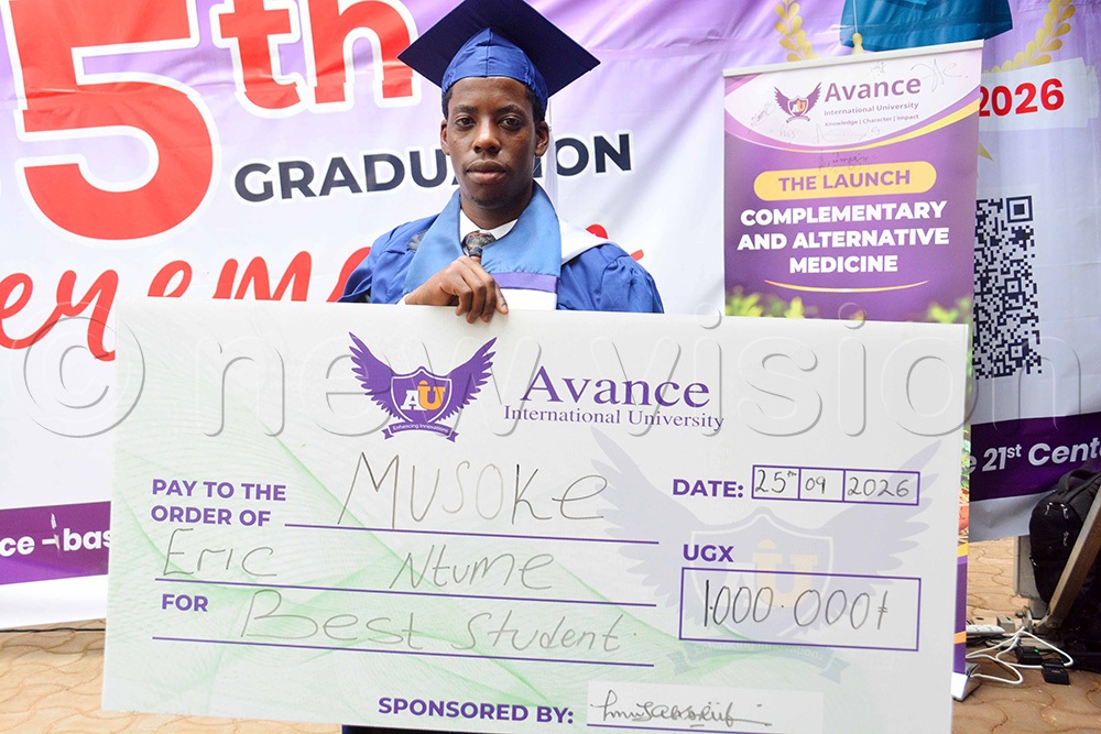 Eric Ntume displays a dummy cheque of sh1 million awarded to him for being the best student at Avance International University. (Photo by Francis Emorut)