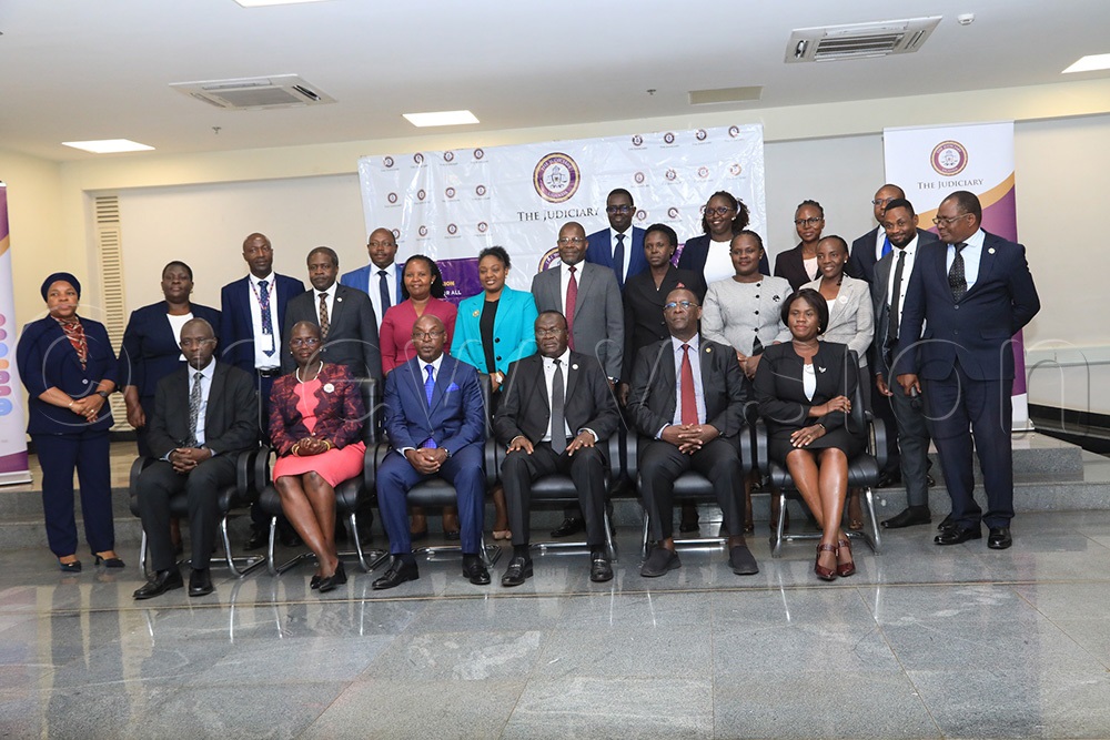 Outgoing Chief Justice Alfonse Owiny-Dollo poses for a photo with senior Judiciary officials during his official handing over of office. (Photo by David Lukiiza)