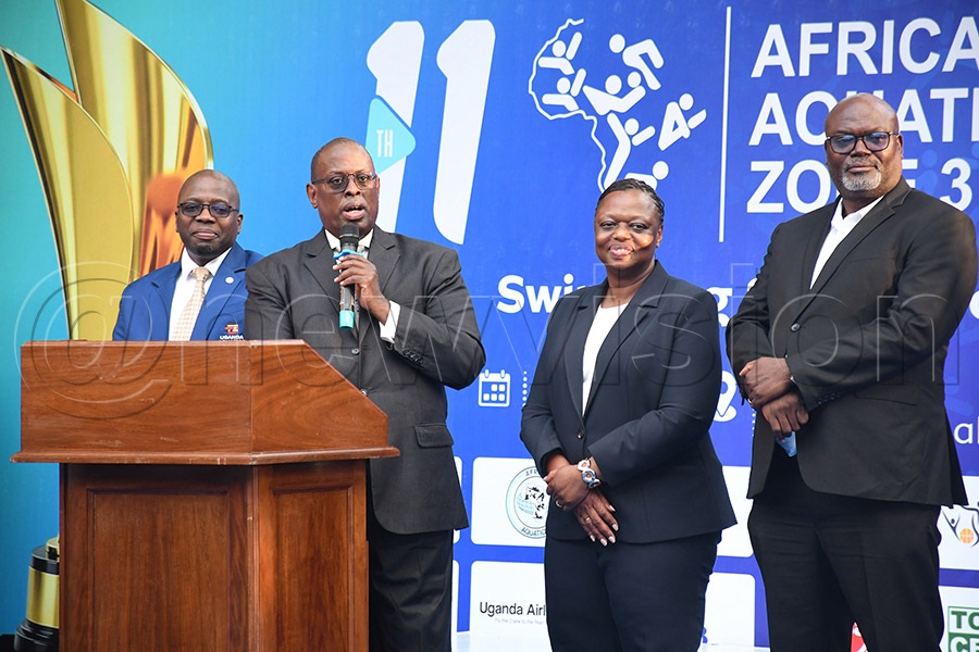 Africa Aquatics Region 3 president Donald Rukare (2nd left) addresses participants falnked by Uganda Aquatics president Moses Mwase (left) and some regional officila during the opening ceremony at KISU. Photo Michael Nsubuga