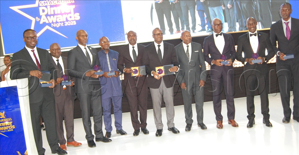 The trustee of SMACKOBA, Prof. Frederick Ssempebwa (seveth-left) shares a photo monemet with some of the recipients of the SMACKOBA Distinguished Alummi Achiever Award during the awards dinner at Hotel Africana on Friday, December 5.