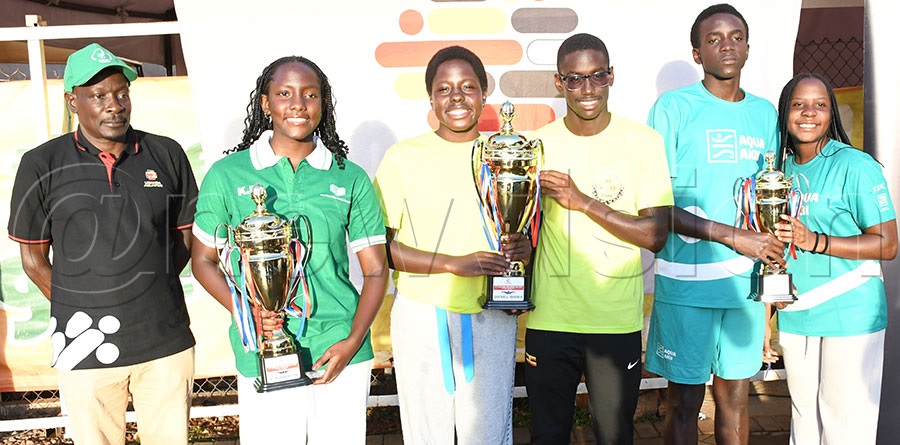 The captains of the top three schools: Paloma Kirabo (2nd left) of Aga Khan, School of Tomorrow Alexis Akol and Kyle Kaweesa and the North Green School's Carlton Musenze pose with their trophies  after the  21st Uganda Aquatics Independence Swimming Gala at Greenhill Swimming Pool, October 11, 2025. Photo by Michael Nsubuga