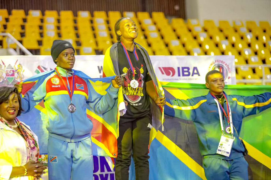 Featherweight Fatuma Nabikolo (centre) smiling for her gold during a medal podium at the just concluded Zone 3 Africa Boxing Championship in Kenya. (Courtesy photo)