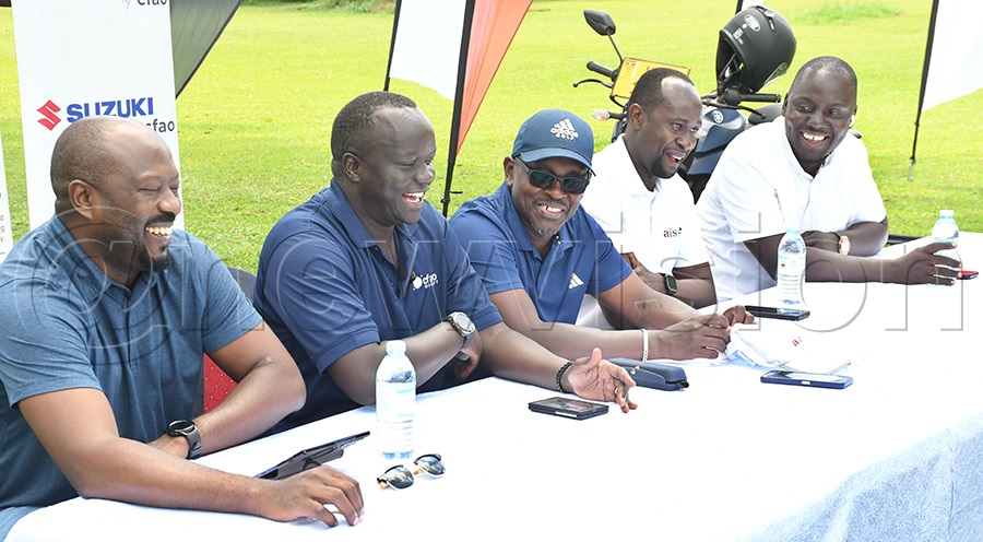 Mary Louise Simkins Memorial Golf Club's chairman Herbert Kamuntu (center), shares a light moment with Kenneth Tumusiime (left), Howard Wodomal, Arnold Baguma, Tim Lwanga and Howard Wodomal, Arnold Baguma, and Tim Lwanga during the launch of the Homecoming tournament. Photo by Michael Nsubuga