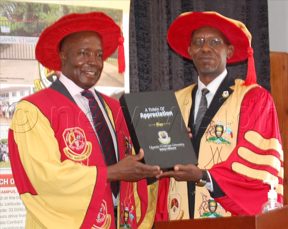 Francis Kamulegeya (left), receives a gift from the Vice Chancellor of Uganda Martyrs University, Prof. Patrick Edrin Kyamanywa. Kamulegeya delivered the Commencement Lecture of the 32nd Graduation Ceremony of Uganda Martyrs University at the university's main campus at Nkozi, in Mpigi district on Saturday, October 17, 2026.