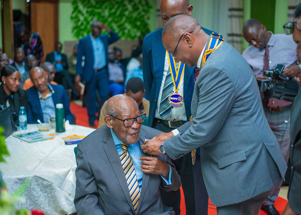 Rotarian and presidential adviser, Rtr Robert Sebunya (seated) being recognized for his outstanding service by The District Governor (DG) of District 9213, Geoffrey Kitakule during an event held at Greenfield Gardens, Kanyanya. 