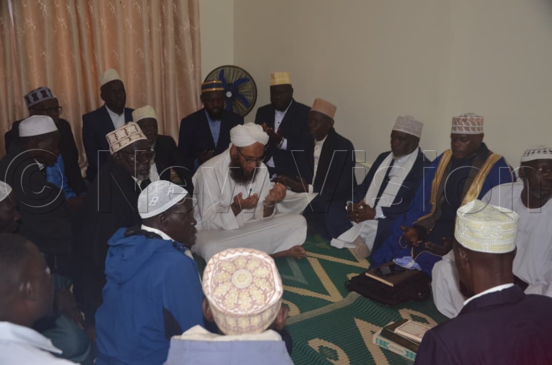 Muslims gather to offer prayers beside the body of the late Gen. Moses Ali.