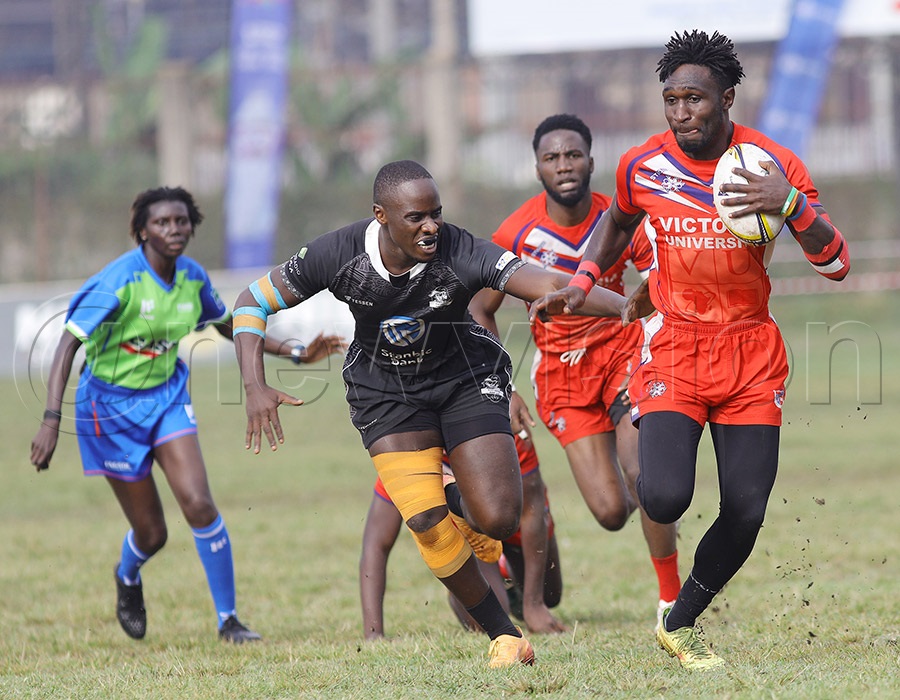 Stanbic Black Pirates' William Nkore attempts to stop Victoria Sharks' Humphrey Asirigwa during the Kyadondo Rugby 7s. PHOTO: Johnson Were