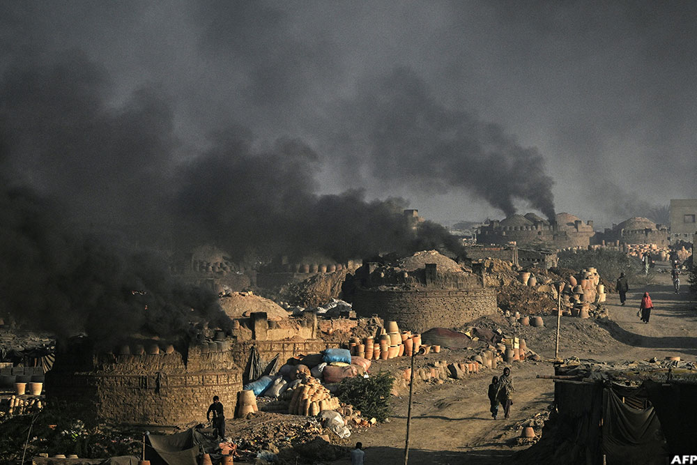 Smoke billowing from kilns at a potters' colony in Karachi, Pakistan
