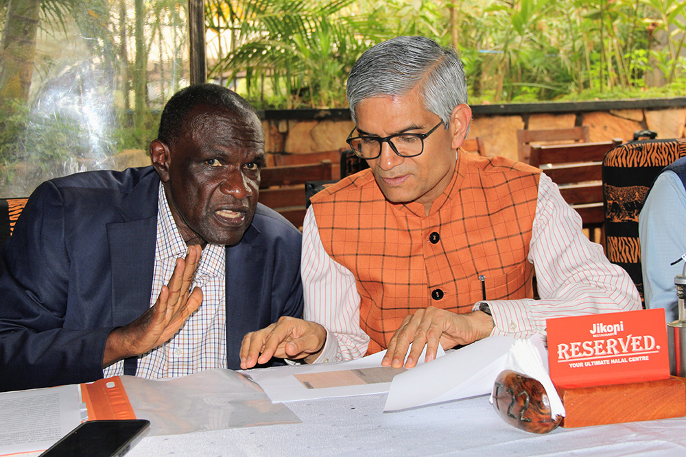 High Commissioner of India to Uganda Upender Singh Rawat and Secretary Office of the President, Hajji Yunus Kakandehas, interacting during the occasion. (Courtesy photo)