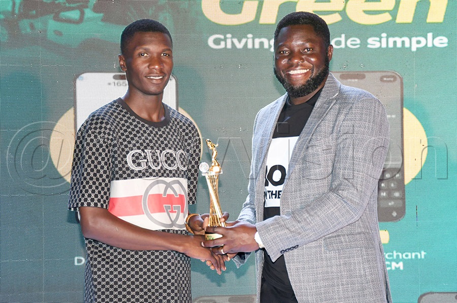 Pastor Julius Rwotlonyo (right) the Team Leader at Watoto Church Ministries presents a trophy to amateur winner Juma Abiti after the Watoto Golf Tornament at Kitante, August 8, 2026. Photo by Michael Nsubuga