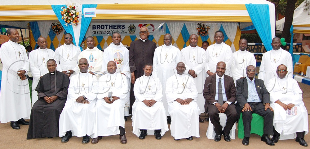 The Brothers of Christian Instruction (wearing a white cassock with a crucifix) share a photo-moment with the priests and representatives of the Board of Governors of Caltec Academy. This was during the celebration of the centenary of the Brothers' advent in Uganda, at the school in Makerere on Saturday, June 13, 2026. (Photo by Mathias Mazinga)