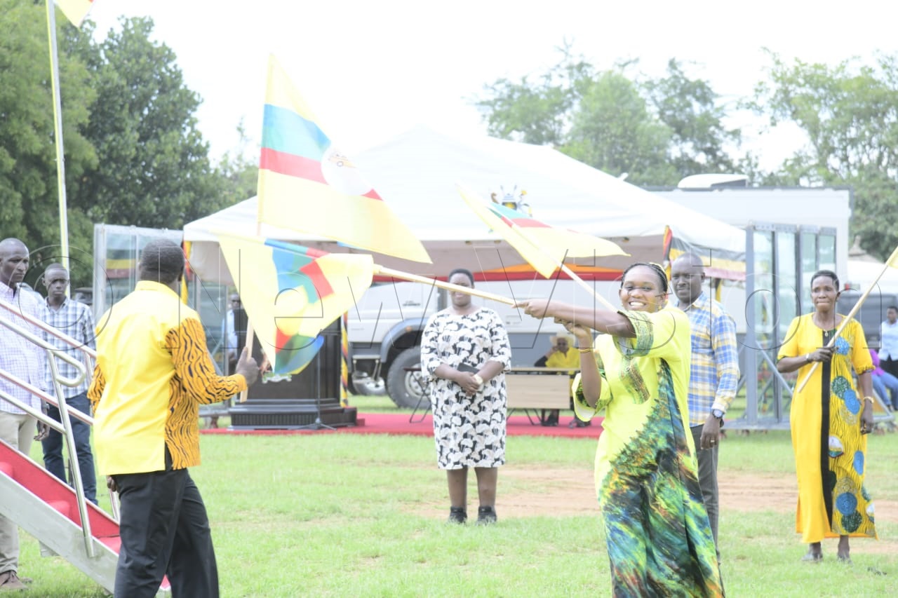 Hon. Phiona Nyamutoro waving the NRM flag.