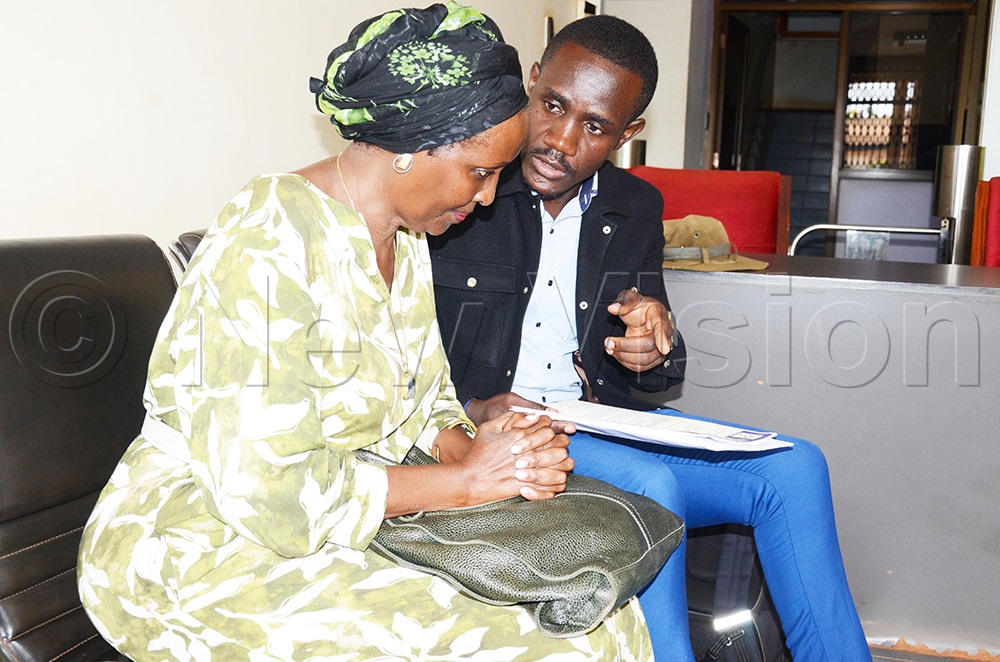 Edith Byanyima, the daughter of the longest-serving DP National Chairman, Boniface Byanyima, with DP member Julius Ddumba, before the release of the letter on Monday, April 13, 2026. (Photo by Isaac Nuwagaba)