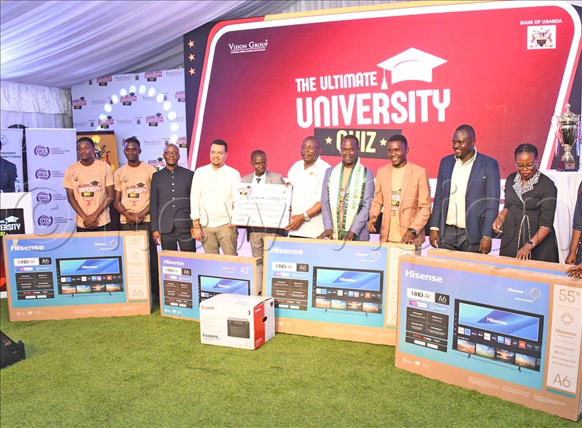 The executive director of NEMA, Dr. Barirega Akankwasah (3rd left) and the head of marketing, Hariss International Krystal Premium Water, Sam Hooper (4th left) handing over gifts to Busitema University students who emerged 3rd in the Ultimate University quiz season three. This was during the awarding ceremony at Vision Group head offices in Kampala on Thursday, November 27, 2025