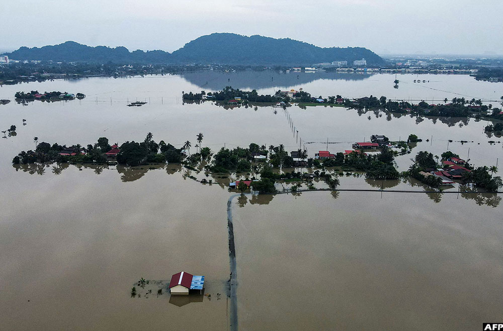 An aerial view shows homes surrounded by flood waters in Kangar in northern Malaysia's Perlis state on November 28, 2025