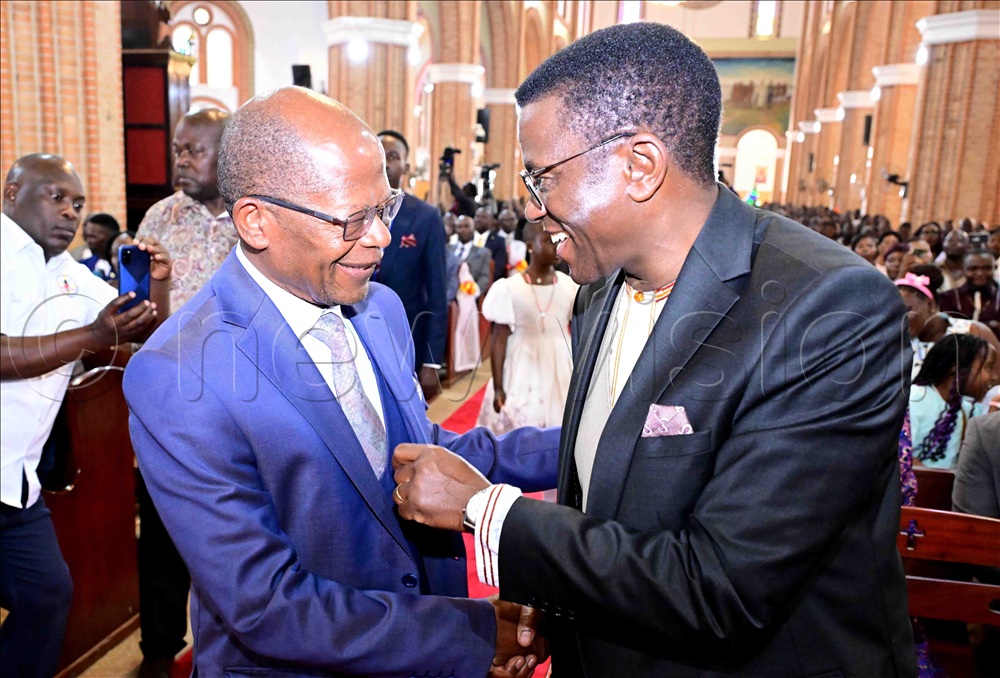 The State Minister for higher Education John Chrysestom Muyingo (left) sharing a light moment with the Katikkiro of Buganda Charles Peter Mayiga before commencement of the Christmas prayers at Lubaga Cathedral on Thursday, December 25, 2025. 