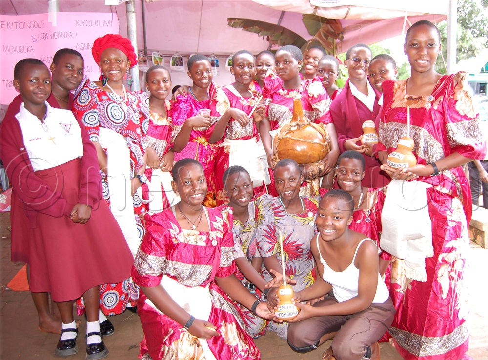 The Tricona students from central Uganda exposing the traditional gourds that were used to drink local brew.