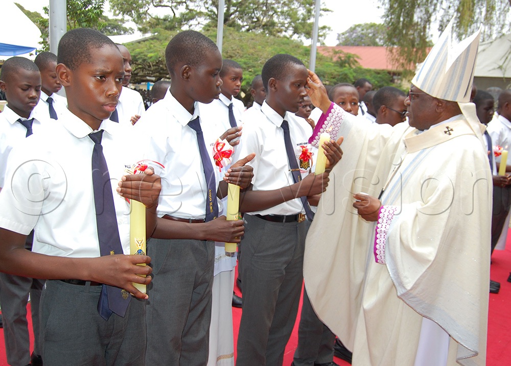 Archbishop Paul Ssemogerere confirming the students of SMACK. (Photo by Mathias Mazinga)