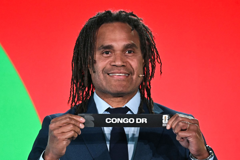 French former player Christian Karembeu shows the paper slip of DR Congo during the 2026 FIFA World Cup Play-Off Tournament draw at the FIFA's Home of Football in Zurich on November 20, 2025. 