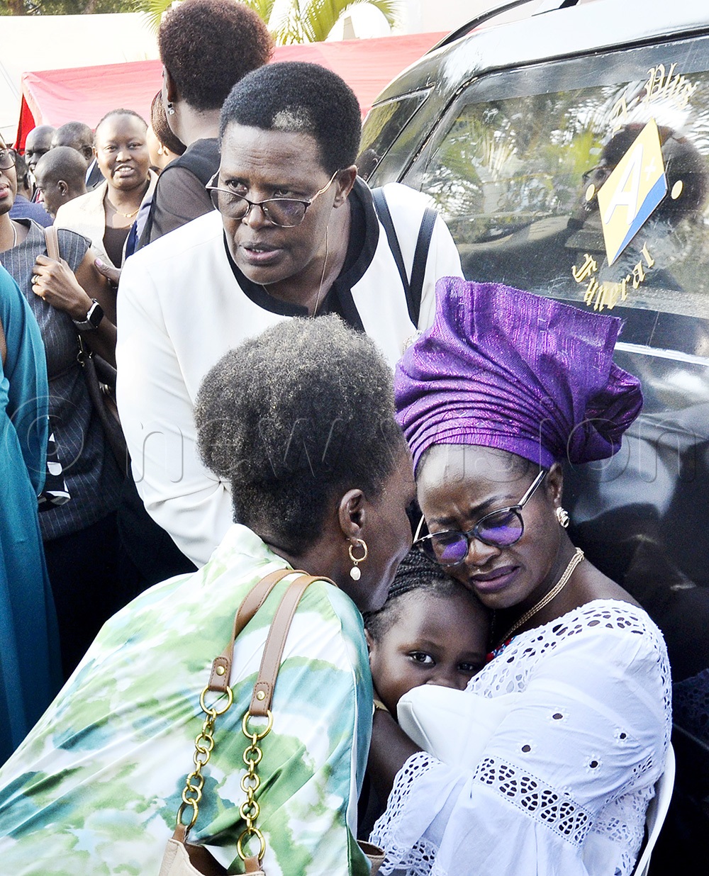 The deputy registrar of the International Crimes Division of the High Court in Uganda, Juliet Harty Haitanga (C) being comforted by relatives and friends after a funeral service of her daughter, late Thelma Abongo Haitanga, at All Saint Cathedral, Nakasero in Kampala on August 5 2025.