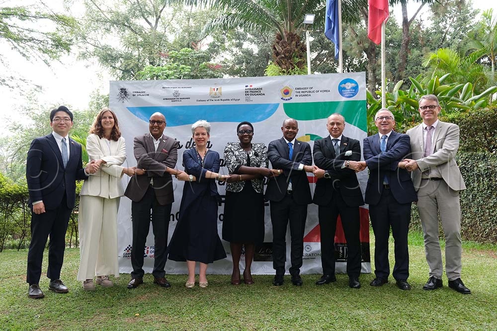 Virginie Leroy (4th L), Ambassador of  France to Uganda hold hands with other diplomatic partners during the launch of the Francophone month at the French Ambassador's residence in Nakasero, on February 27, 2026. (Credit: Hajarah Nalwadda)