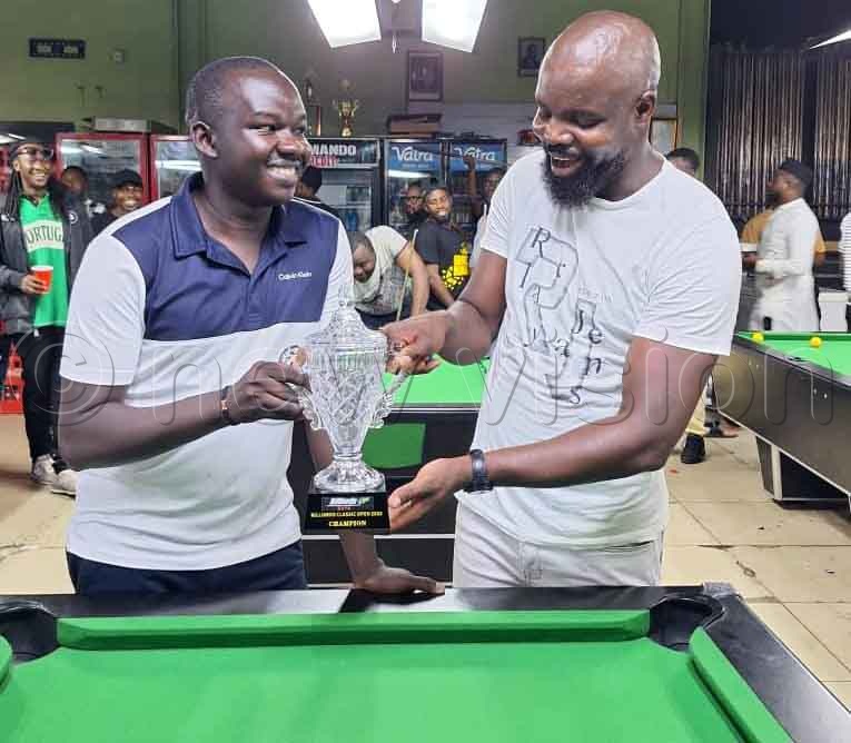 Ceasar Chandiga (left) receiving his trophy. (Credit: Jeff Andrew Lule)