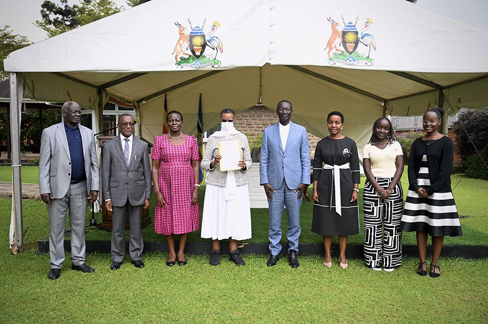 First Lady and Minister of Education and Sports, Hon. Janet K. Museveni, holds the land titles for the 97-acre land donated for Bunyoro University. (Credit: PPU)
