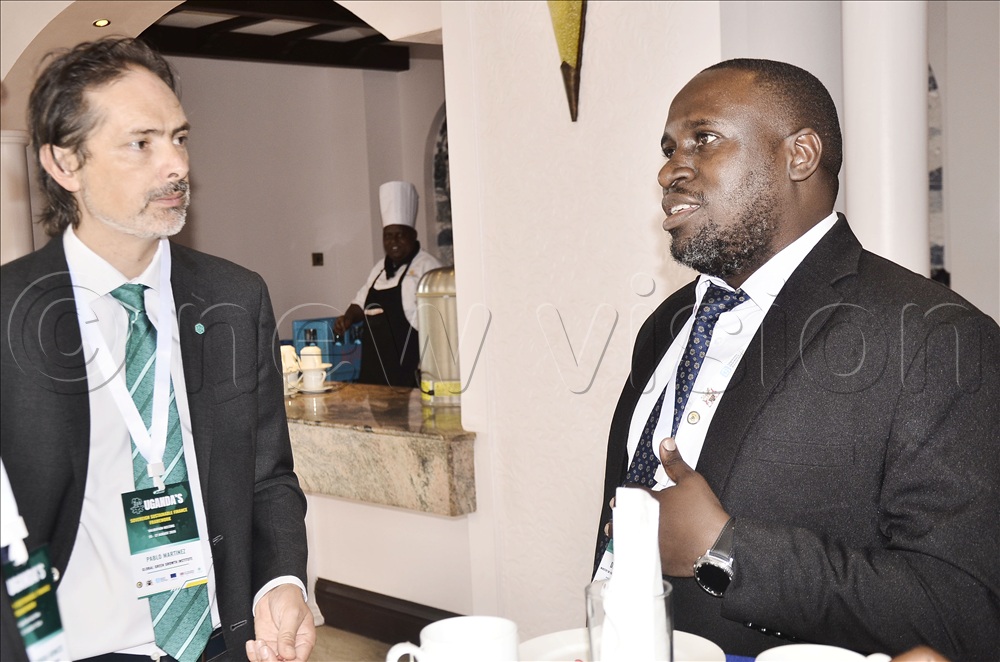 The head of Global Green Growth Institute in Uganda, Pablo Martinez (left), listens to the Head of the Climate Finance Unit in the Ministry of Finance, Planning and Economic Development, Denis Mugaga, during a climate finance conference with the European Union and Global Green Growth Institute at Serena Kigo
