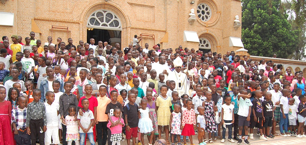 Archbishop Paul Ssemogerere (wearing a white mitre) shares a photo-moment with some of the children who turned up for the celebration of the Feast of Holy Innocents at Lubaga Cathedral on Monday, December 29, 2025. (Photo by Mathias Mazinga)