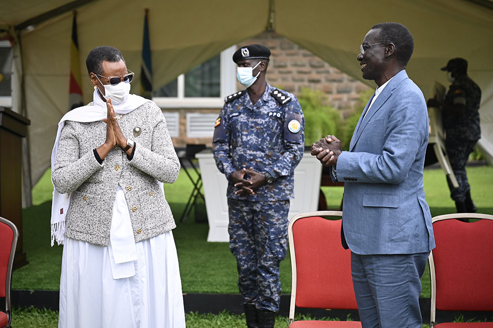 First Lady and Minister of Education and Sports, Hon. Janet K. Museveni, shares a moment of appreciation with Dr. Henry Wamani after receiving land titles for the future Bunyoro University. (Credit: PPU)