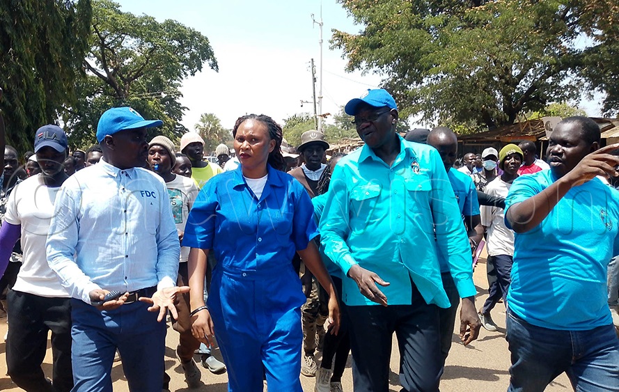 FDC president Patrick Oboi Amuriat flanked by Gweri County MP Tom Julius Ekudo, Soroti City Woman MP Joan Alobo and Soroti West MP Jonathan Ebwalu matching to the Soroti Independence Square. (Photo by Godfrey Ojore)