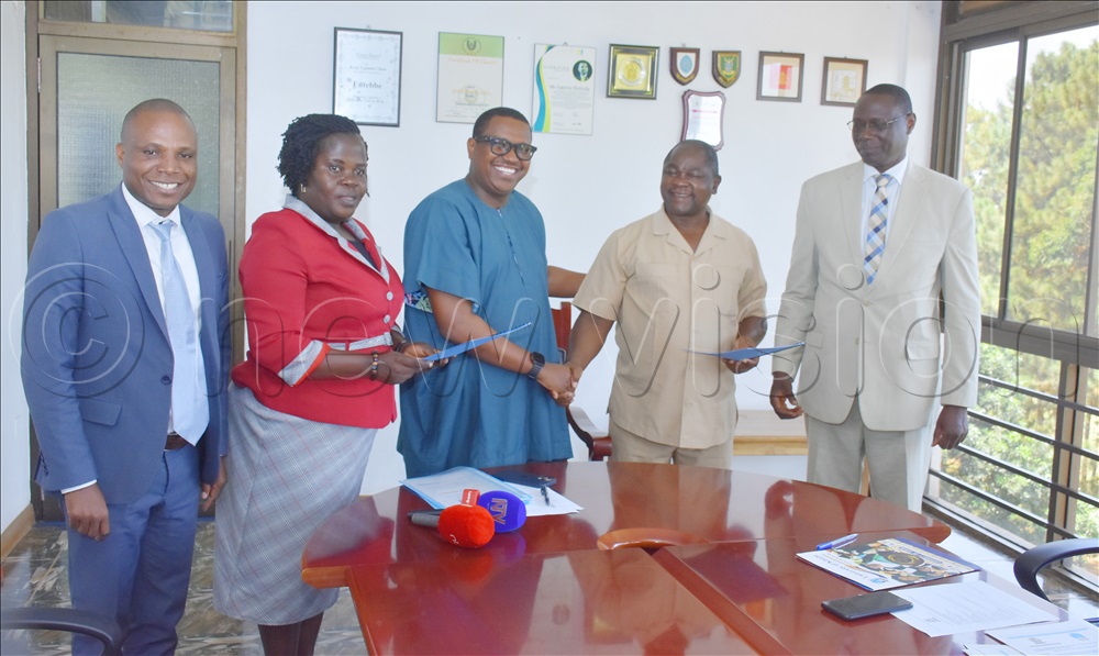 Prof Celestine Kakooza (2nd right) the vice chancellor Kisubi university shaking hands with Fabrice Rulinda (3rd left) the Entebbe municipality mayor in presence of other accompanying officials during the renewal of the MoU between Kisubi university and Entebbe municipality.