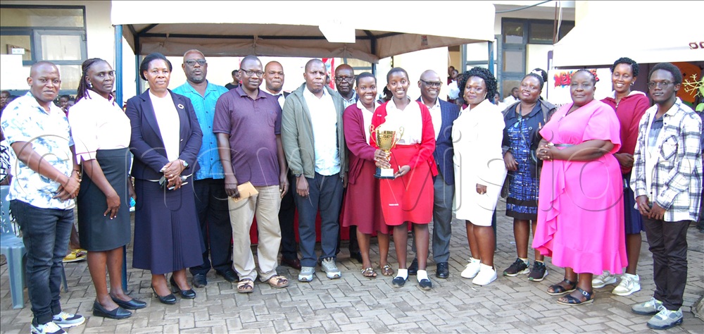 The victorious students from the Chemistry Department of TRICONA (holding a trophy) share a photo moment with the school's administrators/departmental heads, and the visiting adjudicators from the NCDC and SESEMAT at the conclusion of the curriculum exhibition. 