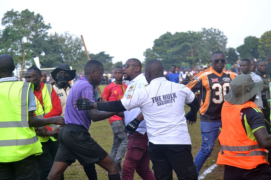 Referee Edward Ssekajjugo being attacked by fans. Photo by Gerald Kikulwe
