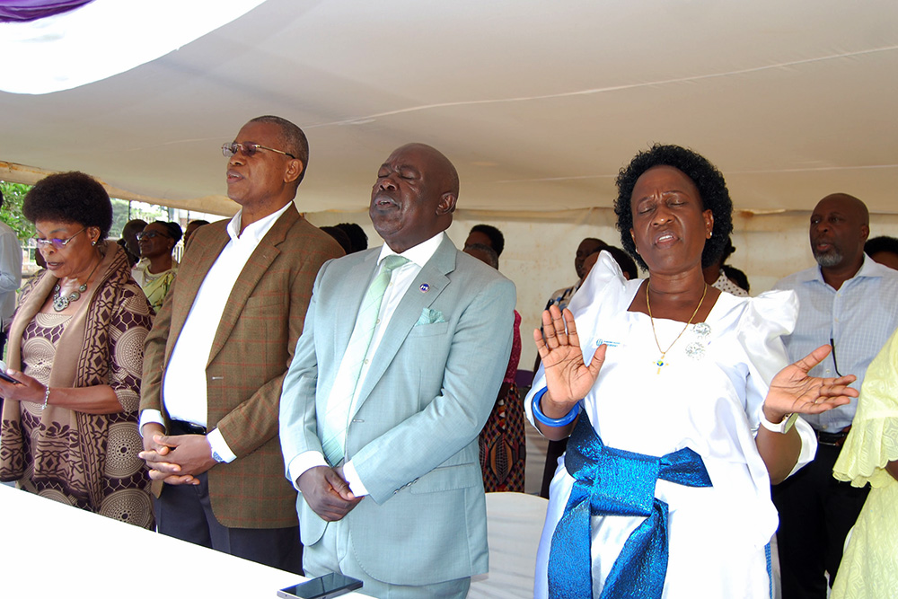 Christians in a praise and worship action during the service. (Photo by Mathias Mazinga)