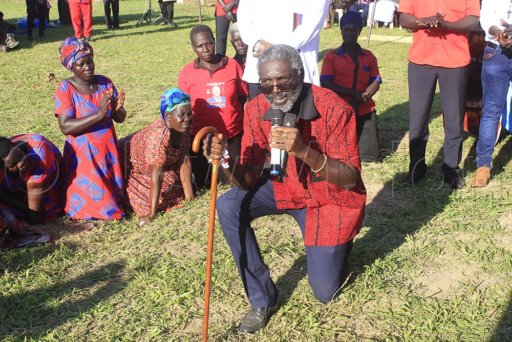 Jimmy Akena, son of former President Milton Obote and current UPC party leader, kneels in honor of his father’s legacy and contributions to nation-building during the memorial service. (Photo by Solomon Okabo)