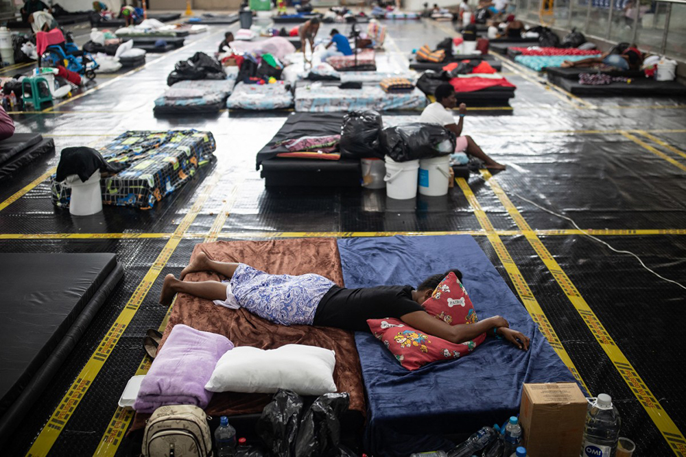 A survivor rests on a provitional shelter at the coliseum after a 7.4 earthquake in Quibdo, Colombia on August 16, 2026. (AFP)