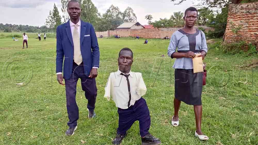 Innocent Odia (C) and his parents. (Credit: Joseph Ekol)