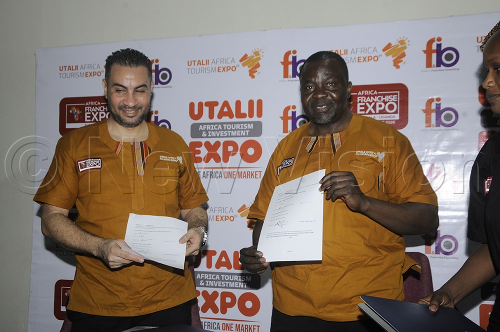 The Chief Executive Officer (CEO) of Franchise Expo Utalii Africa, Ahamed Elsaadany, and Francis Mugoga, Executive Officer of Utalii Africa Tourism and Investment Expo, display their agreement signed for the franchise to hold the African Tourism Expo at the Emin Pasha hotel in Kampala on December 22. (Photo by Wilfred Sanya)