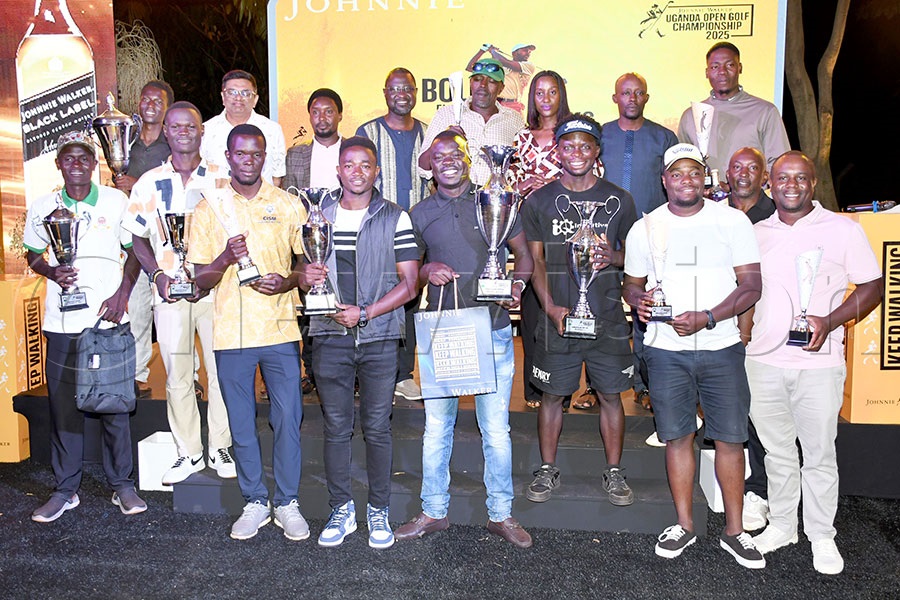 The different winners from the main and subsidiary events pose with their trophies alongside UGU president Moses Matsiko (2nd right-back) and Johnnie Walker brand manager Christine Kyokunda (3rd rignt-back) and UGU president Jackson Were (centre-back) and  other officials after the Johnnie Walker Uganda Golf Open  Championship at the Lugazi Hills Golf and Country Club. Photo by Michael Nsubuga