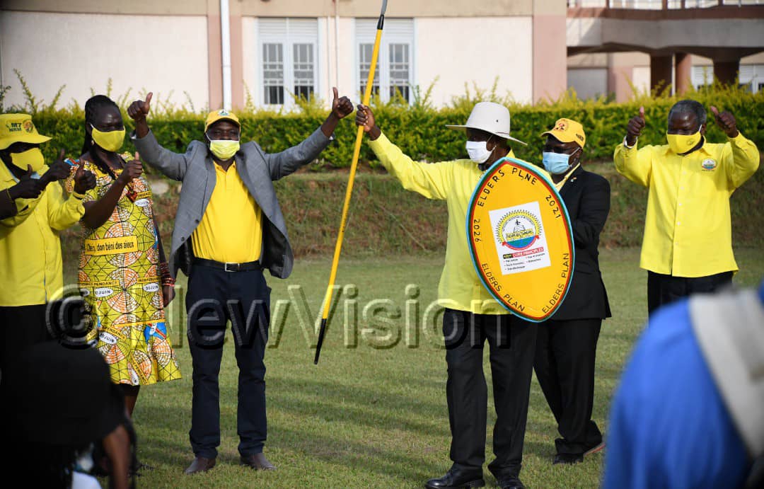 Equipped with the party shield and spear...ready to defend the country once elected again.