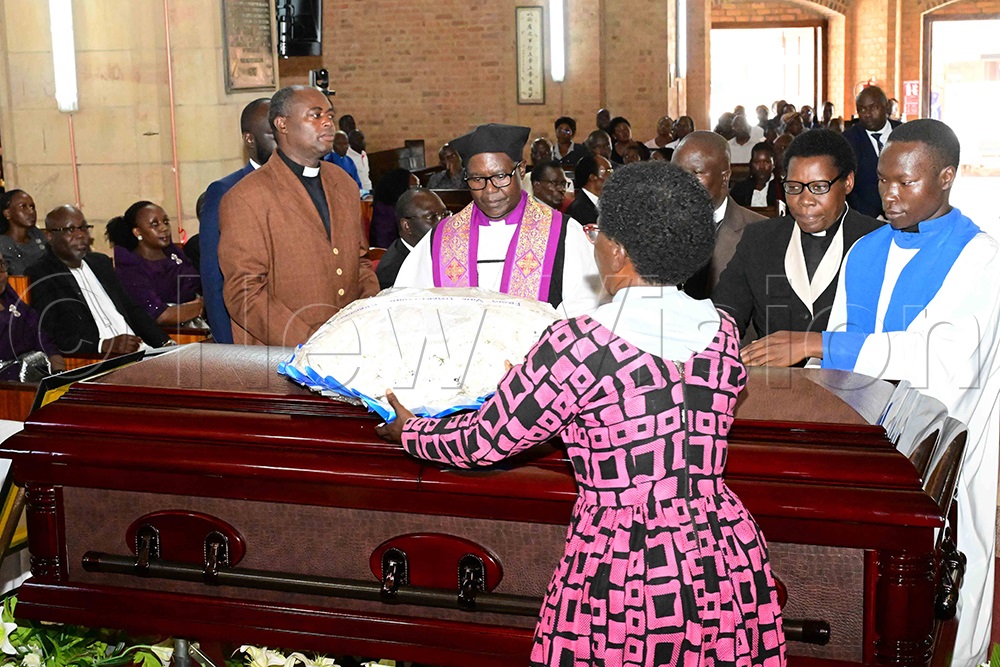 Former Bishop of West Buganda Diocese, Katumba Tamale (third left), joins other clergy in laying wreaths on the casket of the late Bishop Christopher Ssenyonjo during the funeral service. (Credit: Eddie Ssejjoba)
