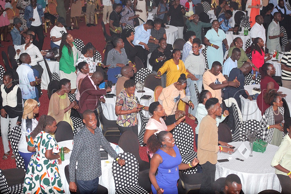 A group of people dancing to Godfrey Kwezi's song during his gospel concert. (Photo by John Musoke)