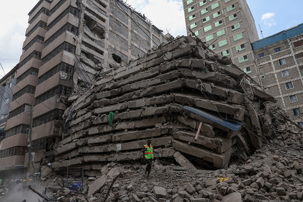 A personnel from the Kenya Defence Forces Disaster Response Battalion inspects the rubble of a collapsed residential building that was still under construction in the Eastleigh neighbourhood of Nairobi on October 23, 2026. (Photo by Tony Karumba / AFP)